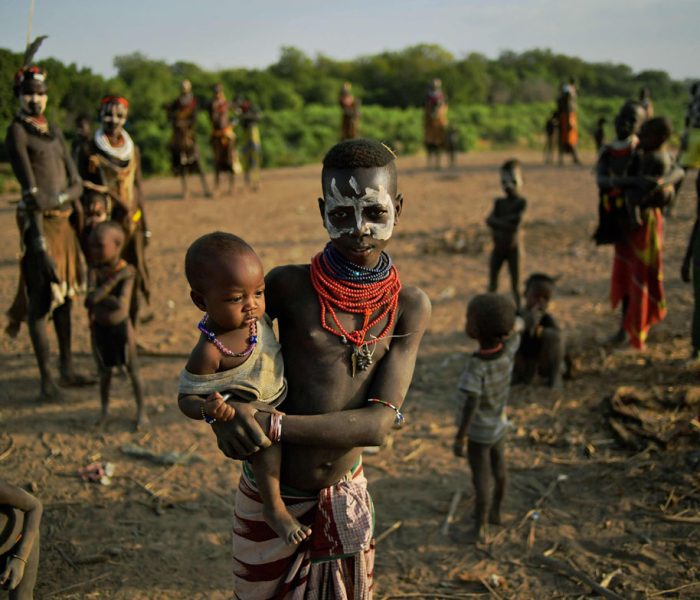 Members of the Karo tribe pose in front of the Omo river in Ethiopia's southern Omo Valley region on September 23, 2016. 
The Karo are a Nilotic ethnic group in Ethiopia famous for their body painting. They are also one of the smallest tribes in the region. The construction of the Gibe III dam, the third largest hydroelectric plant in Africa, and large areas of very "thirsty" cotton and sugar plantations and factories along the Omo river are impacting heavily on the lives of tribes living in the Omo Valley who depend on the river for their survival and way of life. Human rights groups fear for the future of the tribes if they are forced to scatter, give up traditional ways through loss of land or ability to keep cattle as globalisation and development increases.  / AFP PHOTO / CARL DE SOUZACARL DE SOUZA/AFP/Getty Images ** OUTS - ELSENT, FPG, CM - OUTS * NM, PH, VA if sourced by CT, LA or MoD **